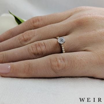 Yellow gold/platinum round brilliant cut diamond engagement ring