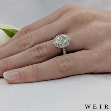 Platinum/yellow oval cut diamond engagement ring