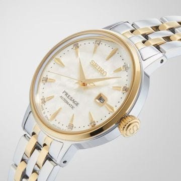Photo of the Seiko Presage Cocktail White Lady 30mm Cream Dial Automatic Watch (SRE010J1) with a stainless steel & gold PVD case, showcasing timeless elegance.