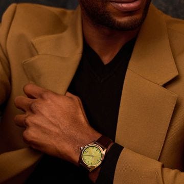 Photo of the Bulova Surveyor 96B427 watch showcasing a vibrant green dial, stainless steel case, leather strap, and automatic movement.