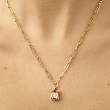 Photo of the Close-up of a female model wearing DYRBERG/KERN Octa Gold Tone Crystal Pendant Necklace with a rose crystal 460530