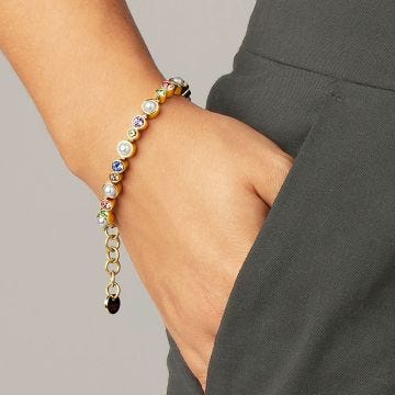 Photo of the  DYRBERG/KERN Sacha Gold Tone Bracelet adorned with multi-coloured crystals and faux pearls 450096