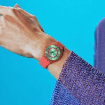 Photo of the Swatch Minty Mango Dream 34mm green dial quartz watch with gradient pink-orange silicone strap, model SS08P111