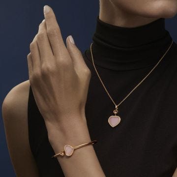 Photo of the Chopard Happy Hearts 18k Rose Gold Pink Opal Diamond Pendant Necklace (79A074-5620) with a heart-shaped pink opal and floating diamond
