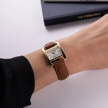 Photo of the Herbelin Ve Avenue 23.4x19mm Silver Dial Quartz Watch 17537P08GD, featuring a sleek rectangular stainless steel case, minimalist silver dial, and luxurious brown leather strap