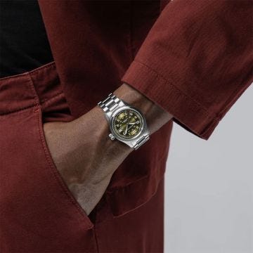 Photo of the Hamilton Khaki Field 38mm Green Dial Automatic Watch H70455160, showcasing a rugged green dial with luminous numerals, automatic movement, and a stainless steel bracelet 