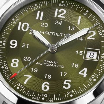 Photo of the Hamilton Khaki Field 38mm Green Dial Automatic Watch H70455560, featuring a rugged green dial, luminous hands and markers, and a brown leather strap