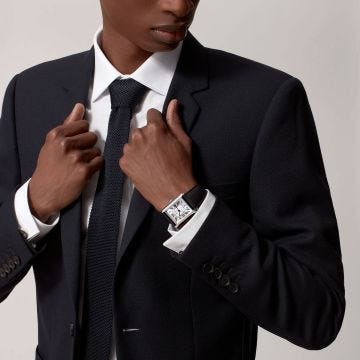 Photo of the Cartier Tank Must 41 x 31mm Silvered Dial Automatic Watch WSTA0040, featuring classic Roman numerals, blued steel hands, and a black leather strap 