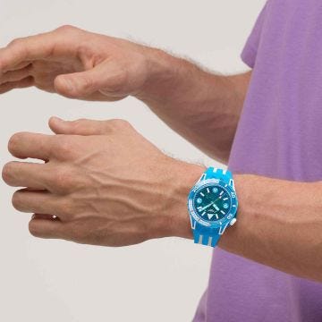 Photo of the Swatch Blue Fire 44mm blue dial quartz watch with blue silicone strap, model SSCU09S100